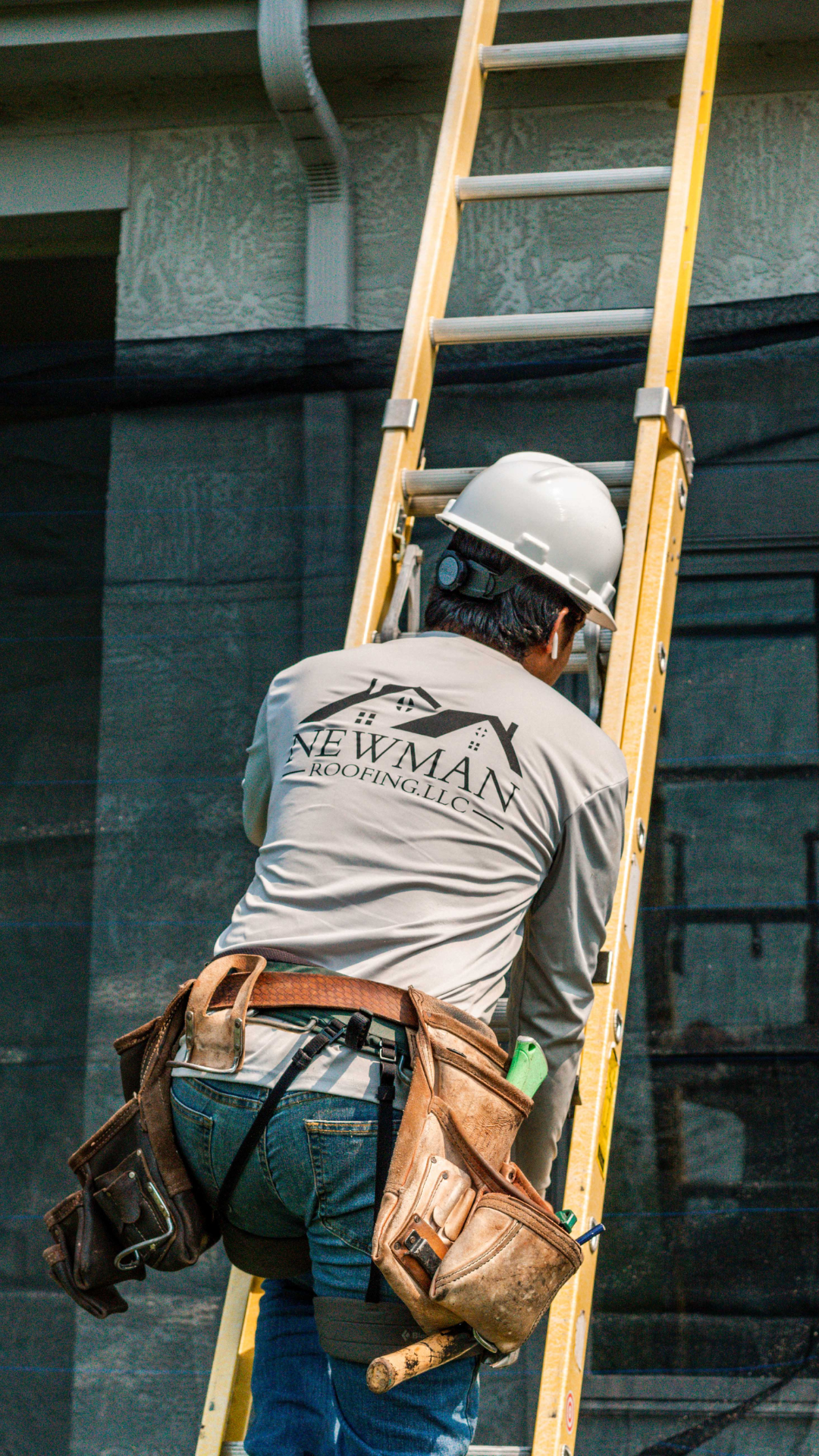 Newman Roofing worker on a roof